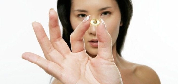 Woman holding fish oil capsule