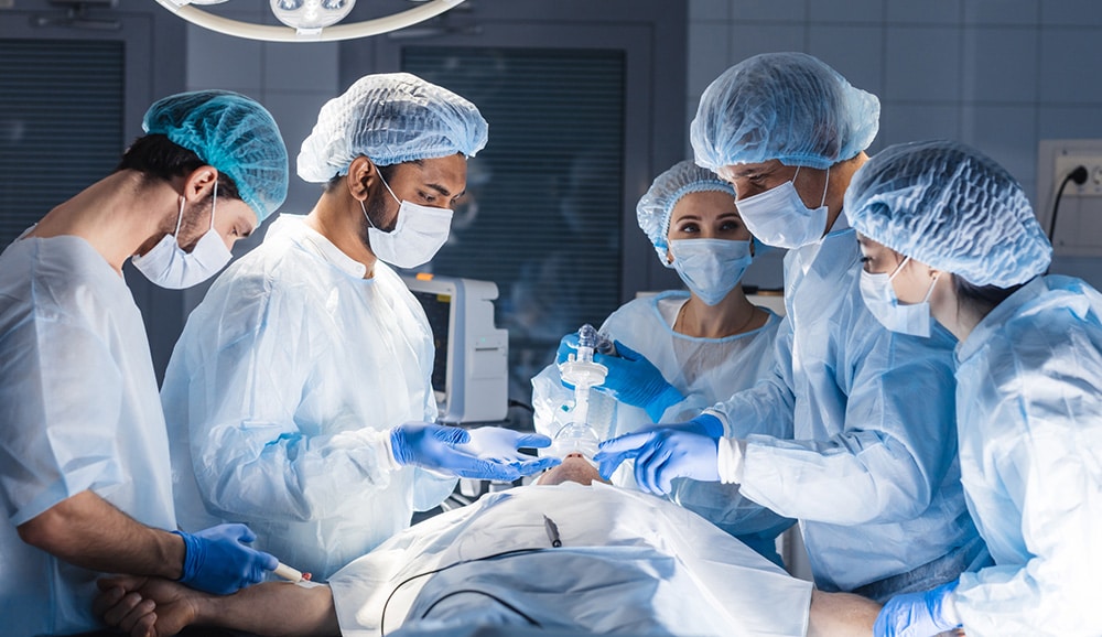 a group of doctors performing surgery on a patient