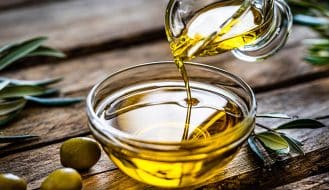 olive oil being poured into a bowl