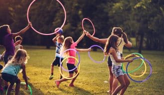 children playing with hula hoops