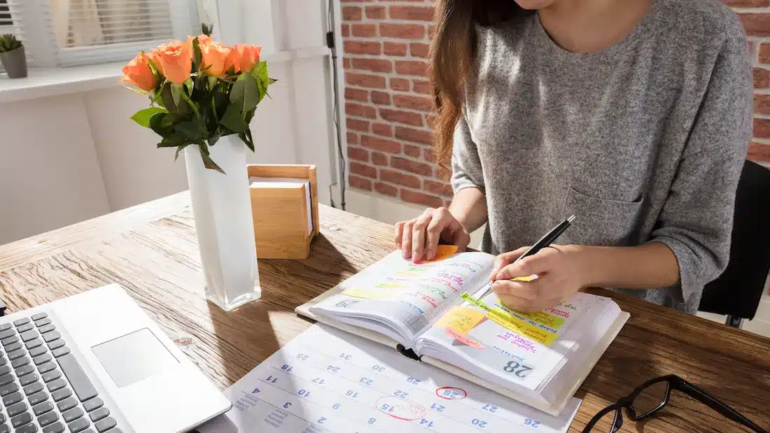 a person filling out a planner